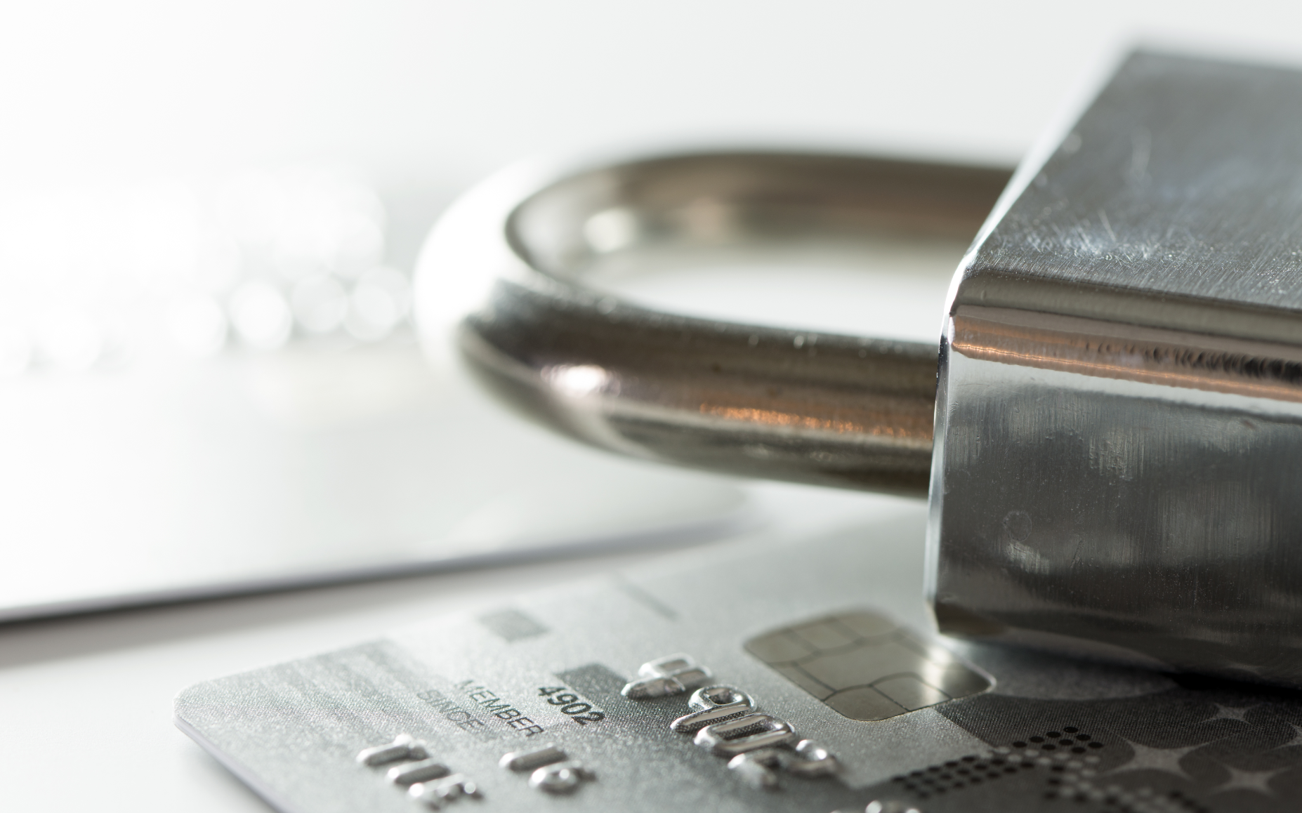 credit card on a table with lock placed on top