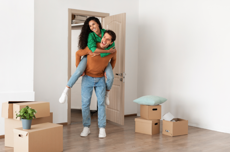 couple walking into their first home after learning how to fix your credit.