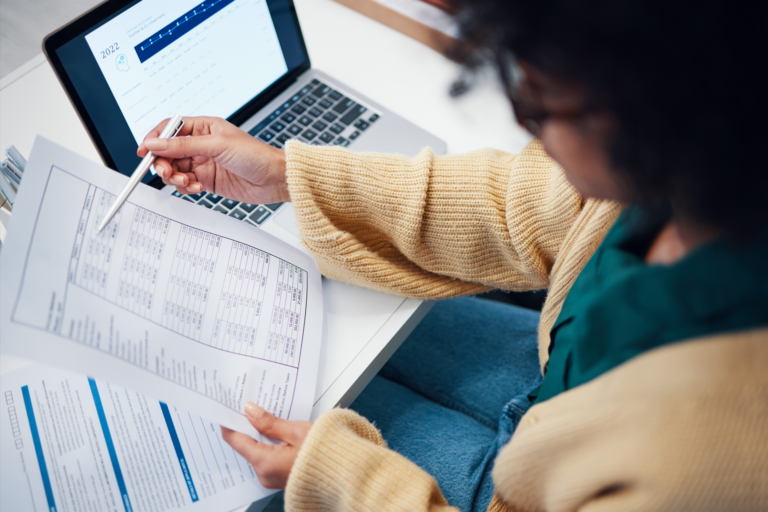 Closeup, financial and woman with FCRA violations documents, laptop and accounting with budget, payment and internet