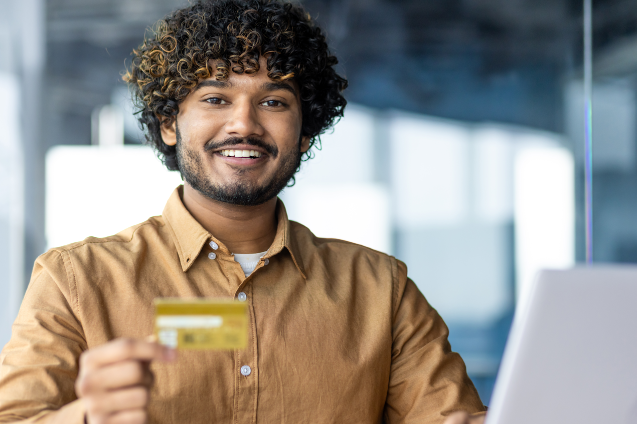 Portrait of young successful hispanic businessman inside office learning what is credit insurance, man smiling and looking at camera